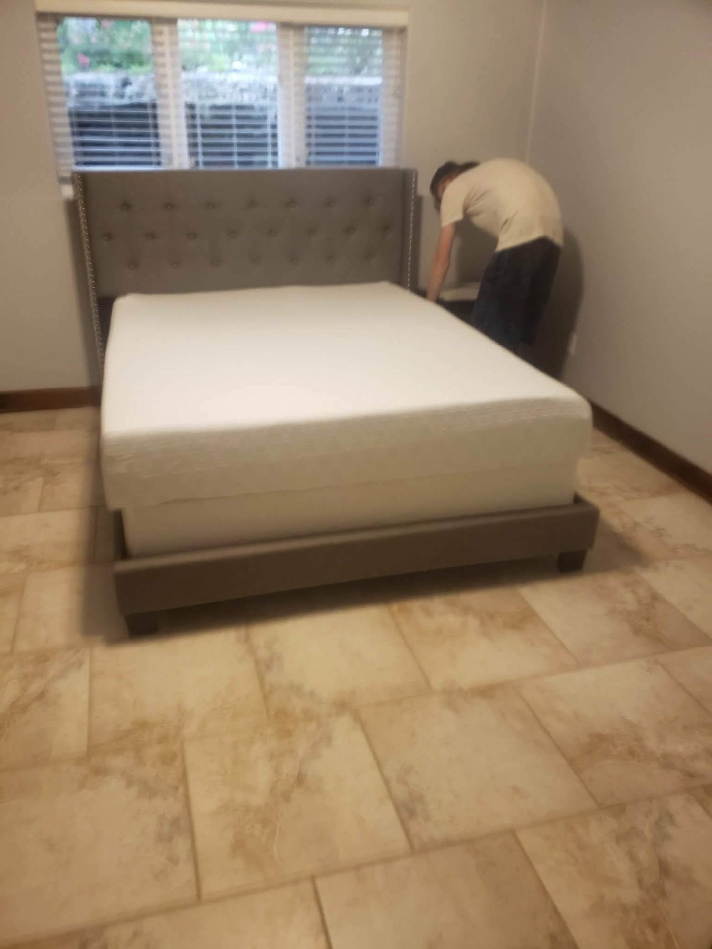 Bed frames being assembled inside the rental during turnover