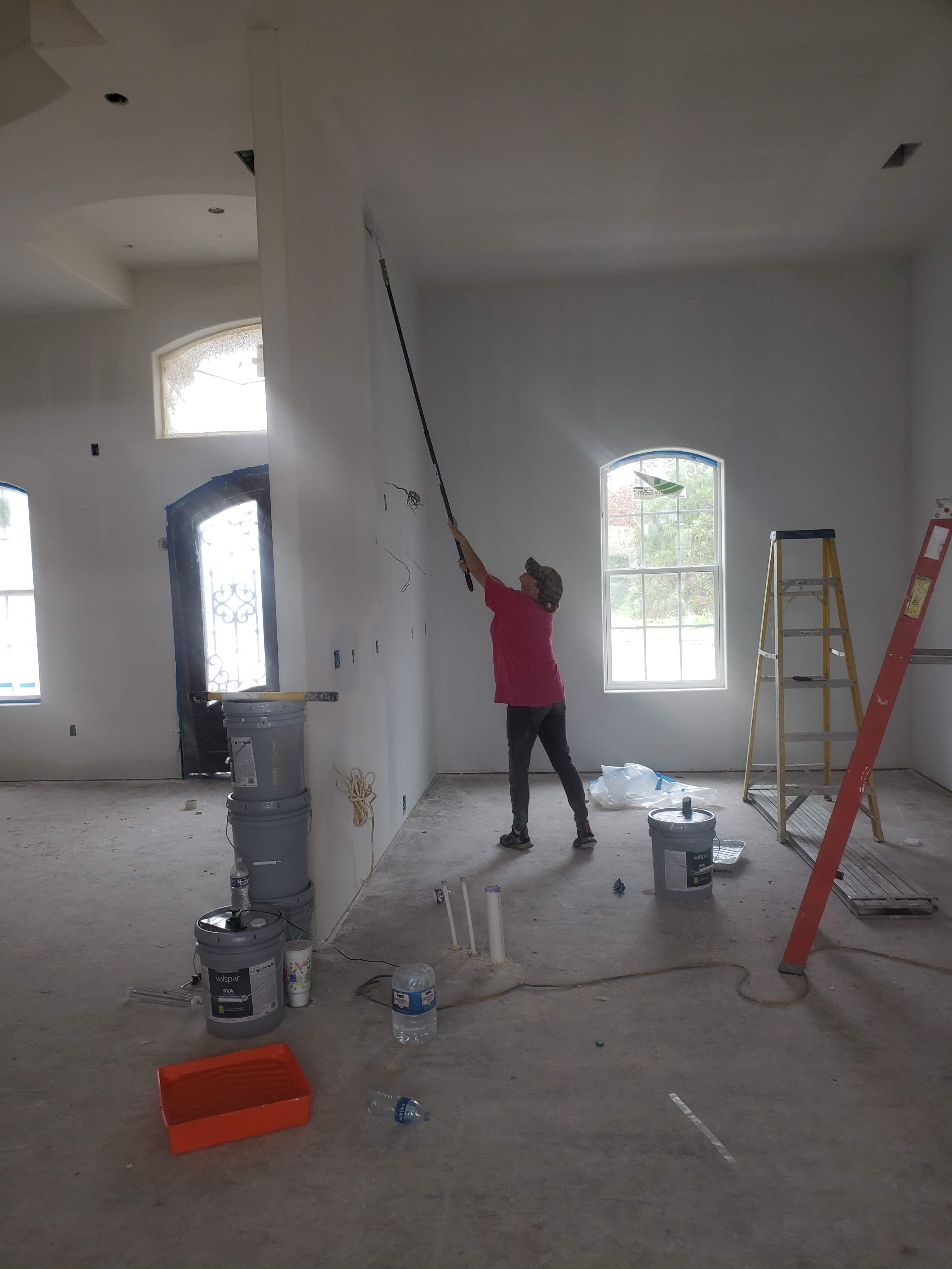 Straight Line Painting owner rolling a fresh coat of paint on interior walls of a Branson home
