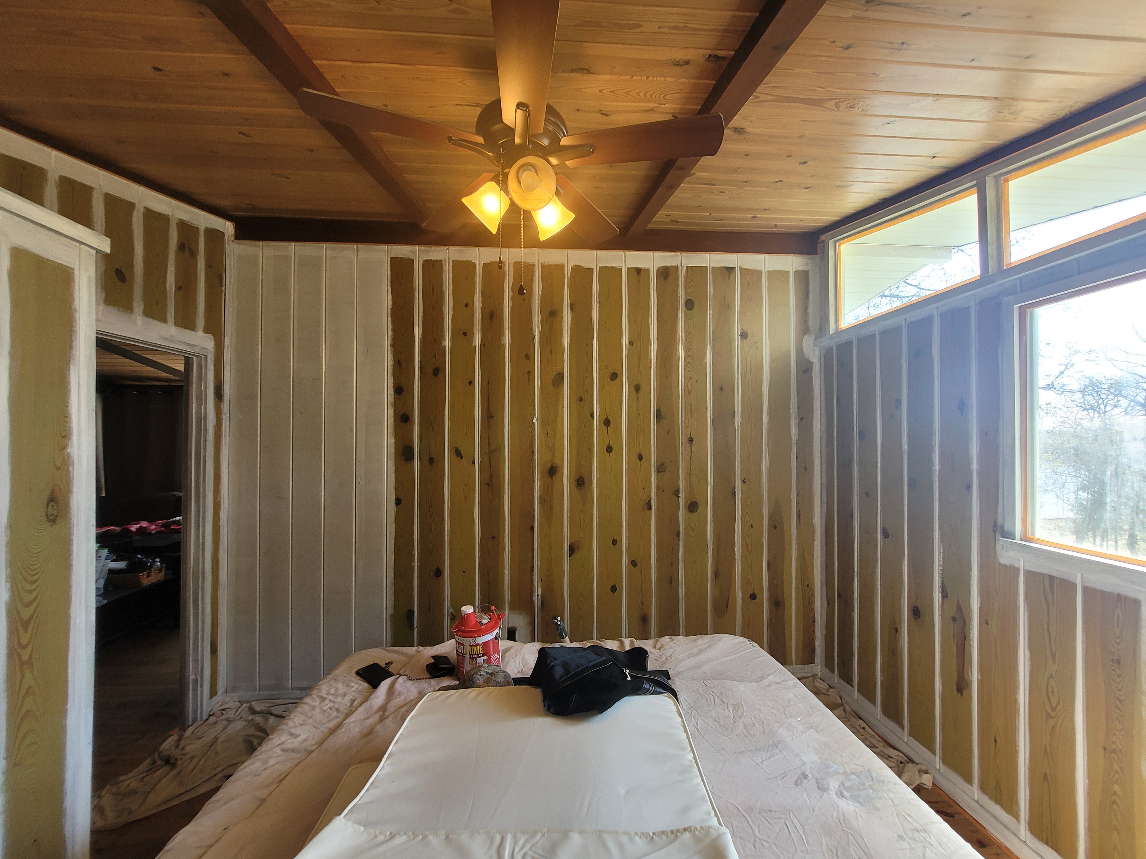 Bedroom with raw pine walls before painting